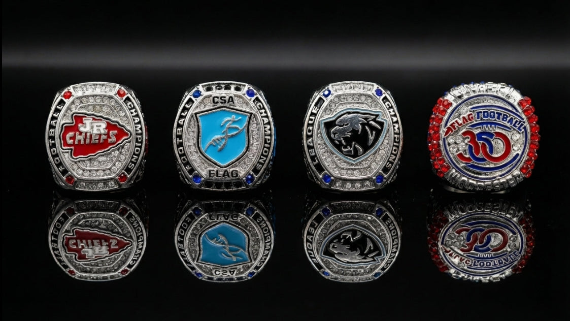 Four custom youth sports championship rings with team logos